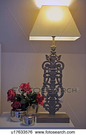 Rose blossoms and table lamp View Large Photo Image Stock Photograph - Rose blossoms and table lamp. Fotosearch