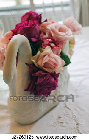 Rose blossoms in swan figurine View Large Photo Image Stock Photography - Rose blossoms in swan figurine. Fotosearch