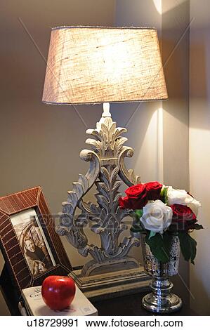 Rose blossoms, photographs and table lamp View Large Photo Image Stock Image - Rose blossoms, photographs and table lamp. Fotosearch