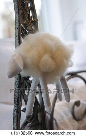 Stock Photo - Sheep figurine hanging at bedpost. Fotosearch