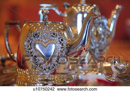 Stock Image - Silver tea pot with heart. Fotosearch