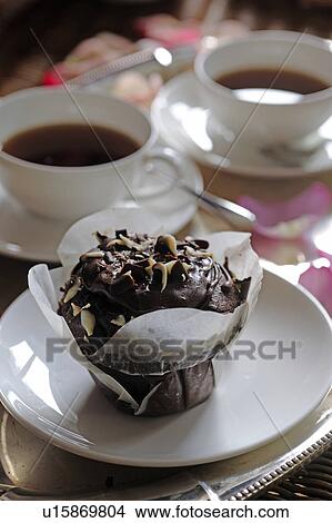 Picture - Small chocolate cake and two cups of coffee. Fotosearch