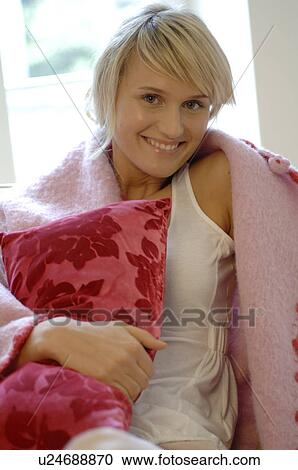Stock Image - Smiling young woman at home. Fotosearch