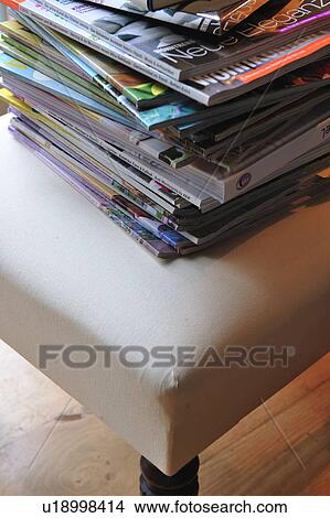 Stack of magazines on chair View Large Photo Image Picture - Stack of magazines on chair. Fotosearch