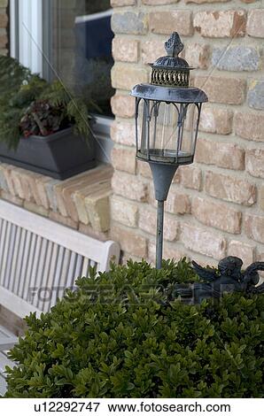 Storm lamp in front of a house View Large Photo Image Stock Photo - Storm lamp in front of a house. Fotosearch