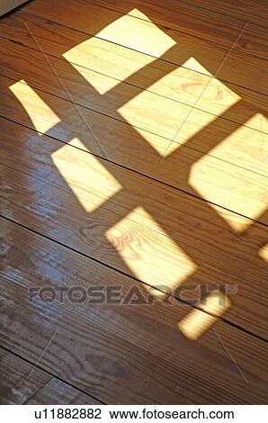 Sun shining through window on wooden floor View Large Photo Image Stock Image - Sun shining through window on wooden floor. Fotosearch