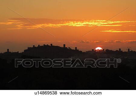 Stock Photo - Sunset behind town. Fotosearch