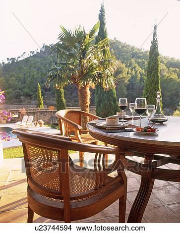 Table on terrace with coffee cups and wine glasses View Large Photo Image Picture - Table on terrace with coffee cups and wine glasses. Fotosearch