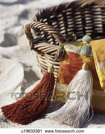 Stock Image - Tassels at wicker basket. Fotosearch