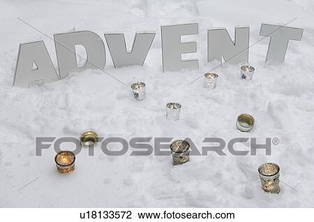 Tea candles and word advent in snow View Large Photo Image Stock Image - Tea candles and word advent in snow. Fotosearch