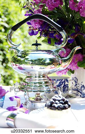 Teapot and flowers on garden table View Large Photo Image Stock Image - Teapot and flowers on garden table. Fotosearch