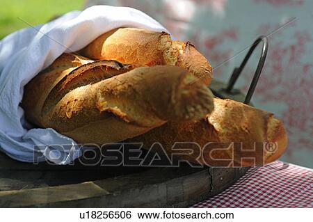 Three baguettes in wooden bowl View Large Photo Image Stock Photograph - Three baguettes in wooden bowl. Fotosearch
