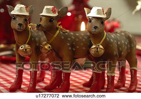 Three Christmas deer figurines standing in row View Large Photo Image Stock Image - Three Christmas deer figurines standing in row. Fotosearch