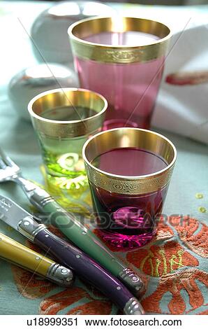 Three colored glasses and cutlery View Large Photo Image Stock Image - Three colored glasses and cutlery. Fotosearch