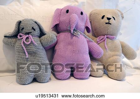 Three cuddly toys on bed View Large Photo Image Stock Image - Three cuddly toys on bed. Fotosearch