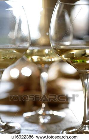 Stock Photograph - Three glasses of white wine. Fotosearch