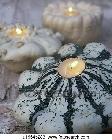 Stock Image - Three tea lights in decorative tea light holders. Fotosearch