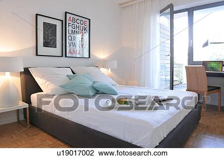Stock Image - Tray with coffee cups and bread on bed. Fotosearch