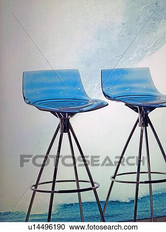 Stock Image - Two blue chairs in front of big wave. Fotosearch