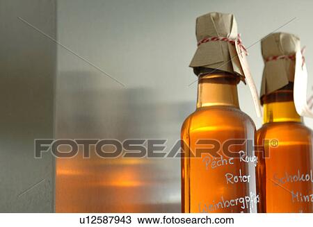 Two bottles of self-made liqueur View Large Photo Image Stock Image - Two bottles of self-made liqueur. Fotosearch