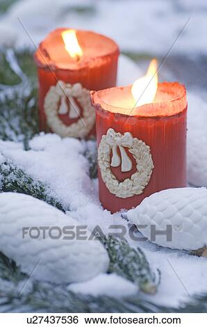 Two burning candles in snow View Large Photo Image Stock Photograph - Two burning candles in snow. Fotosearch