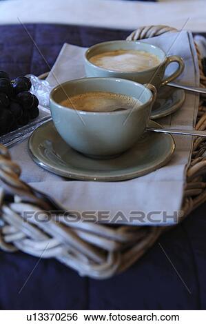 Two cups of coffee and grapes on tray View Large Photo Image Stock Photograph - Two cups of coffee and grapes on tray. Fotosearch