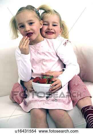 Two girls with bowl of strawberries View Large Photo Image Picture - Two girls with bowl of strawberries. Fotosearch