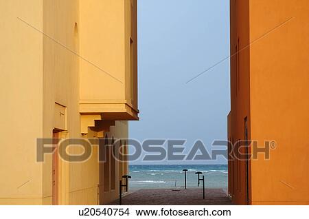 Picture - Two houses, walkway and ocean. Fotosearch