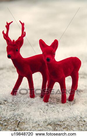 Two red deer figurines in fake snow View Large Photo Image Stock Image - Two red deer figurines in fake snow. Fotosearch