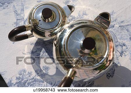 Two silver jugs outdoors View Large Photo Image Stock Image - Two silver jugs outdoors. Fotosearch