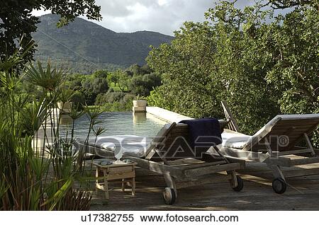 Two sun loungers by the poolside View Large Photo Image Stock Photography - Two sun loungers by the poolside. Fotosearch
