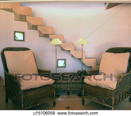 Two wicker chairs in corridor in front of stairs View Large Photo Image Stock Photo - Two wicker chairs in corridor in front of stairs. Fotosearch