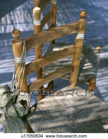 Picture - Two wooden chairs and cord. Fotosearch