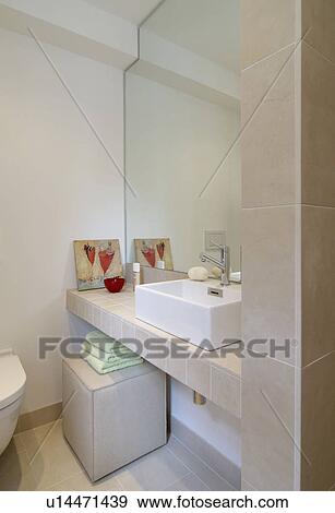 Stock Photo - Wall mirror and sink in modern bathroom. Fotosearch