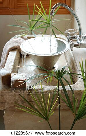 Stock Photo - Water flowing into washbasin. Fotosearch