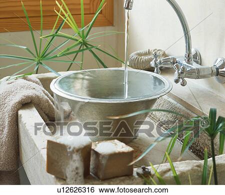 Stock Photograph - Water flowing into washbasin. Fotosearch