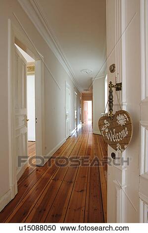 Stock Image - Welcome sign at door knob and floor. Fotosearch