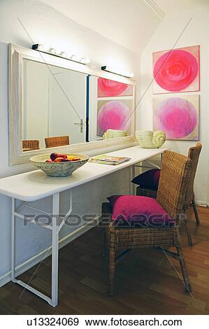 Stock Photo - Wicker chair at vanity table and mirror. Fotosearch