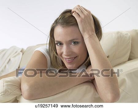 Woman lying on sofa View Large Photo Image Stock Photo - Woman lying on sofa. Fotosearch