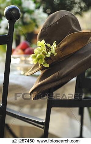 Womans hat at garden table View Large Photo Image Stock Image - Womans hat at garden table. Fotosearch