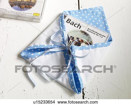 Wrapped gift with CD View Large Photo Image Picture - Wrapped gift with CD. Fotosearch