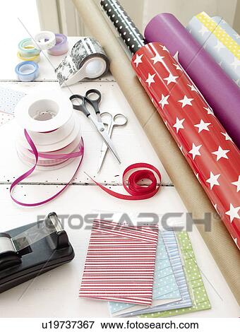 Wrapping paper, ribbons and tape dispenser View Large Photo Image Stock Photo - Wrapping paper, ribbons and tape dispenser. Fotosearch
