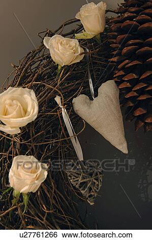 Wreath with rose blossoms and decorative heart View Large Photo Image Stock Photograph - Wreath with rose blossoms and decorative heart. Fotosearch