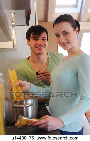 Young couple in kitchen cooking spaghetti and drinking red wine View Large Photo Image Stock Photography - Young couple in kitchen cooking spaghetti and drinking red wine. Fotosearch