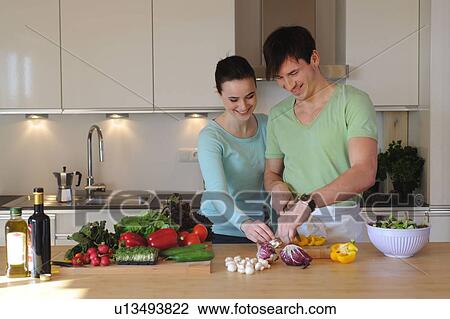 Young couple in kitchen preparing salad View Large Photo Image Stock Image - Young couple in kitchen preparing salad. Fotosearch