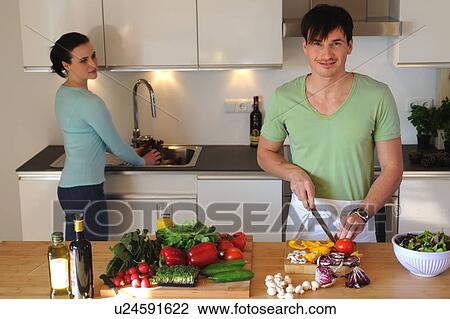 Young couple in kitchen preparing salad View Large Photo Image Stock Image - Young couple in kitchen preparing salad. Fotosearch