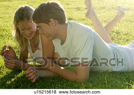 Stock Photo - Young couple lying in meadow. Fotosearch