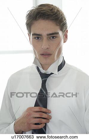 Young man wearing shirt and tie View Large Photo Image Stock Image - Young man wearing shirt and tie. Fotosearch