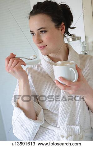 Young woman drinking coffee in bathroom View Large Photo Image Stock Image - Young woman drinking coffee in bathroom. Fotosearch