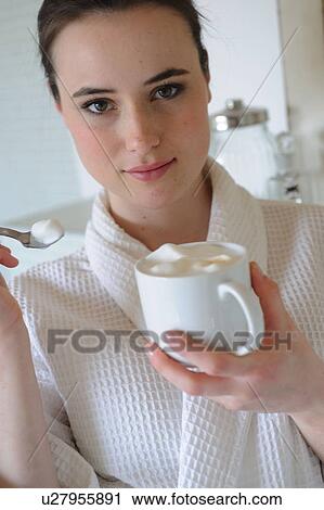 Young woman drinking coffee in bathroom View Large Photo Image Stock Image - Young woman drinking coffee in bathroom. Fotosearch